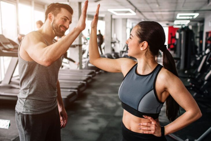 Couple high-fiving at the gym